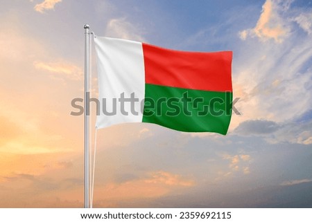 Madagascar flag waving on sundown sky