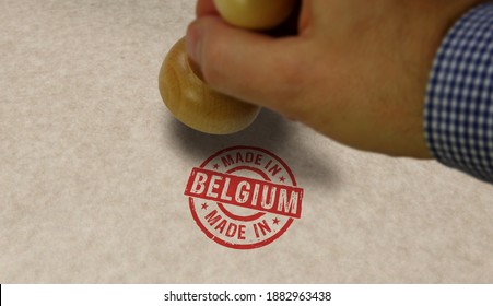 Made in Belgium stamp and stamping hand. Factory, manufacturing and production country concept.