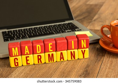 Made in Germany written on a wooden cube in a office desk