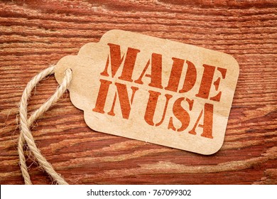 Made In USA Sign - Red Stencil Text On A Paper Price Tag Against Grunge Wood