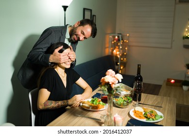 I Made You Dinner. Attractive Husband Covering His Wife's Eyes To Surprise Her With A Delicious Fancy Dinner At Home For Their Anniversary