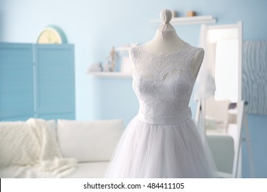 Made-up wedding dress on mannequin in studio