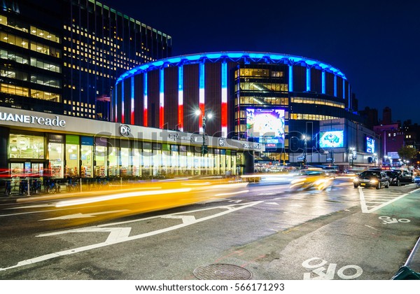 Madison Square Garden,\
New York, USA - 17 October, 2016: Illuminated stadium with car\
riding around.