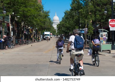 Madison, Wisconsin - 8 August 2019: 3 Cyclists Riding On State Street Show That Madison Is A Bike Friendly Town