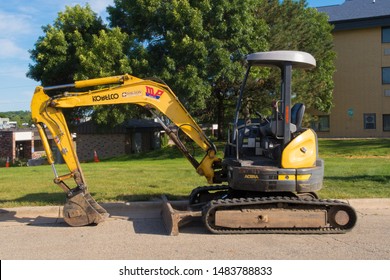 Madison, Wisconsin - 8 August 2019: A Kobelco Acera Excavator With A Drawbar And Dozer Blade