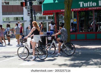 Madison, Wisconsin, United States Of America - June 19, 2021: People Riding Electric Bicycles On The Streets Of Madison, Wisconsin