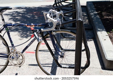 Madison, Wisconsin, United States Of America - June 19, 2021: A Sports Bicycle Parked In A Bike Holder On The Sidewalk