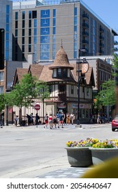 Madison, Wisconsin, United States Of America - June 19, 2021: People Walking Around The Street With A Blue Building In The Background And Copy Space