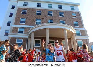 Madison, Wisconsin / United States - September 20, 2017: College Students Enjoy Their Game Day Party While Having A Good Time On The Lake. They Wear Their School Color Red While Dancing And Singing. 