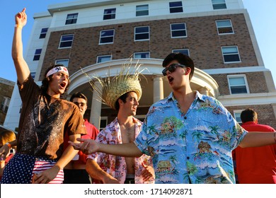 Madison, Wisconsin / United States - September 20, 2017: College Students Enjoy Their Game Day Party While Having A Good Time On The Lake. They Wear Their School Color Red While Dancing And Singing. 