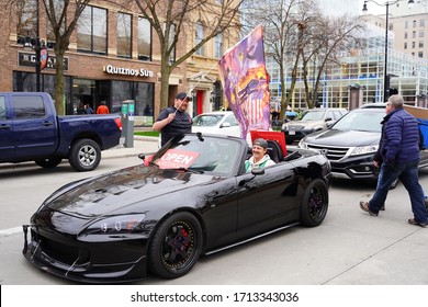 Madison, Wisconsin / USA - April 27th, 2020: Wisconsinites in cars, trucks, and SUVs rallied at the Capitol of Wisconsin gridlocking the streets in protest against safer at home during the COVID-19. 