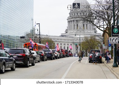Madison, Wisconsin / USA - April 27th, 2020: Wisconsinites in cars, trucks, and SUVs rallied at the Capitol of Wisconsin gridlocking the streets in protest against safer at home during the COVID-19. 