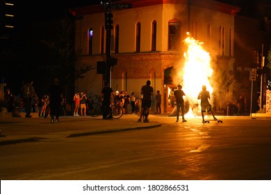 Madison, Wisconsin / USA - August 24th, 2020: Rioters in the streets of wisconsin state capitol madison light fires in garbage bins to protest the death of jacob black of kenosha.