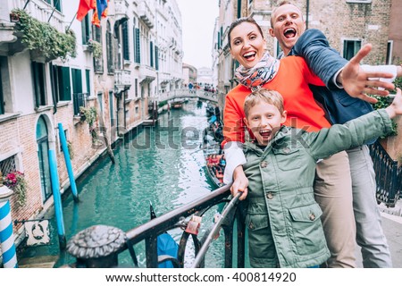 Madly happy family take a selfie photo on the one of bridge in Venice
