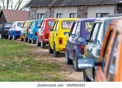 Madona, Latvia - May 01, 2021:  row of colorful stylish vintage Fiat 126 PanCars rental cars, PanCars is a stylish compact car rental for team building , fun races and individual events