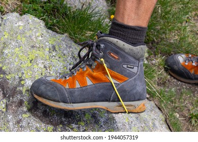 Madonna Di Campiglio, Trentino, Italy - July 9, 2020: Broken Trekkig Boot Repaired By A Lanyard. Leg Of A Man Wearing A Broken Boot.