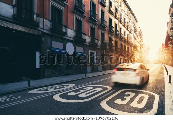 Madrid City center, old street and buildings \
during sunrise in Madrid,\
Spain