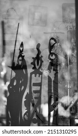 Madrid, New Mexico, U.S.A. - April 19, 2022; Reflection In Glass Of Gallery Store Window In Madrid, New Mexico With Silver Metal Heart Love Sign In Foreground And Metal Decorative People Shapes Behind