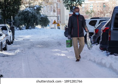 Madrid (Spain); 01 10 2021: The Effect Of Heavy Storm Filomena: Snow, Chaos And Streets Cut Off In The Middle Of Covid-19 Pandemic. Man Walking Through Snow-covered Street.