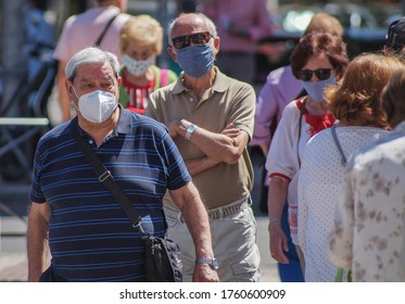 Madrid / Spain - 06/18/2020: Group Of People Walking On The Street. New Situation In Spain About The Pandemic Of Covid-19. People Are Using Mask In Their New Life Routine. 