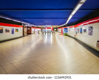 Madrid, Spain; 08 12 2017: Walking through the shining and modern red and blue underground crossing of Fuente De La Mora light metro and commuter rails station in Sanchinarro, Madrid, Spain, Europe.