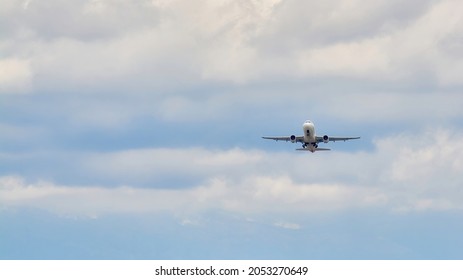 Madrid, Spain; 09-25-2021: Iberia Airline Airbus A320 Plane Folding The Landing Gear After Take Off In A Blue Sky With Clouds