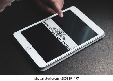 Madrid, Spain. 10-15-2021: Hands Of A Child Holding An Ipad Tablet With The The Times Of India Logo On The Screen. Information Concept.
