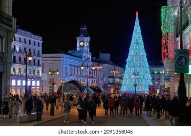 Madrid, Spain; 12-02-2021: Royal Post House And Plaza De La Puerta De Sol, Place Where The End Of The Year Chimes Take Place, With A Christmas Tree Of Lights Cowded