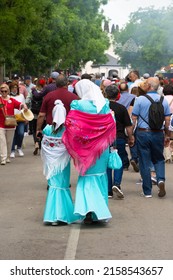 Madrid, Spain; 15th May 2022: A Group Of People Visiting The Stalls At The Saint Isidro Fair. Mother And Daughter With Their Backs Turned Dressed In Traditional Madrid Costume Of 