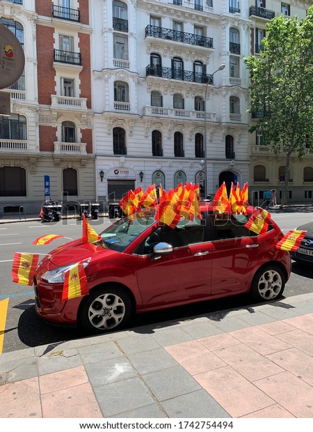 Madrid Spain 23\
May 2020. Car full of spanish flags during demonstration against\
COVID lock down in city\
centre