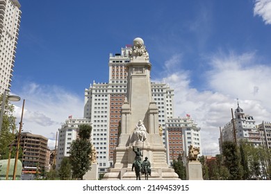 Madrid, Spain - Apr, 21, 2022: View of the stone sculpture of Miguel de Cervantes and bronze sculptures of Don Quixote and Sancho Panza on the Square of Spain (Plaza de Espana).  Revitalized in 2021.
