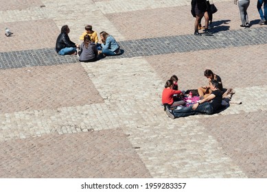 Madrid, Spain - April, 18 2021: People Eating Sitting On The Floor In Plaza Mayor Square In Central Madrid During Restrictions For Coronavirus Covid-19 Pandemic