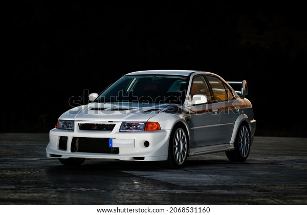 MADRID (SPAIN) August 2, 2020: View of Mitsubishi\
lancer evolution VI tommi makinen limited edition white on helipad\
at sunset.