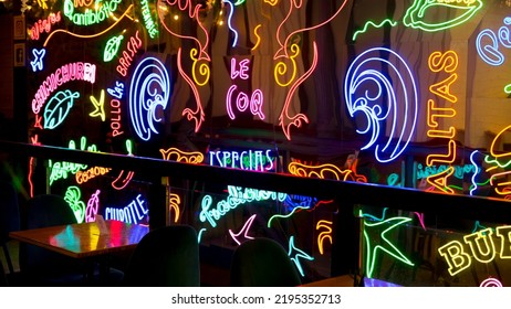 Madrid, Spain, August 25, 2022: Bar Window With Neon Texts At Night, Madrid 
