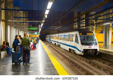 MADRID, SPAIN - DEC 24, 2106: Train arrives at Madrid metro platform. The Madrid Metro is a system serving the city of Madrid, 7th longest metro in the world, with total length of 293 km