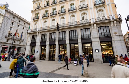 Madrid, Spain - December 2018: Apple Store In Puerta Del Sol,downtown And The City Center Of Madrid, With Pedestrians Passing By Outside The Store.