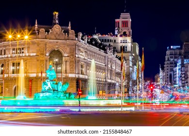 Madrid, Spain - FEB 17, 2022: Night view in long exposure on the Calle de Alcala, Madrid. Historical buildings, palaces, hotels and the cars in motion.