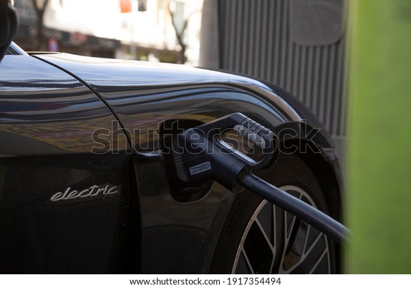 Madrid, Spain - February 07, 2021: Charging\
point for electric and hybrid cars in the center of the city of\
Madrid. Charging station in public roads for electric and\
sustainable mobility.