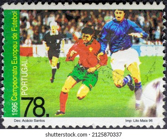 MADRID, SPAIN - FEBRUARY 19, 2022. Vintage Stamp Printed In Portugal Shows Soccer Players In 
UEFA Championships 1996 - England