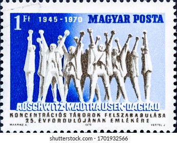 MADRID, SPAIN - JANUARY 11, 2020. Vintage Stamp Printed In Hungary Shows 25th Anniversary Of Liberation Of Concentration Camps, Auschwitz, Mauthausen And Dachau