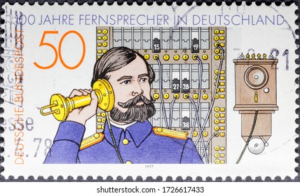 MADRID, SPAIN - JANUARY 25, 2020. Vintage Stamp Printed In Germany Shows Telephone Operator And A Switchboard, German Telephone Centenary