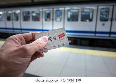 Madrid, Spain. July 2019: Hand with Public transport Multi card of Madrid at an underground metro station