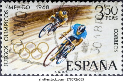 MADRID, SPAIN - JULY 24, 2020. Vintage Stamp Printed In Spain Shows Cyclists For The 1968 Summer Olympics In Mexico