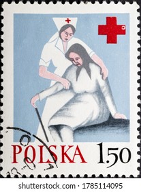 MADRID, SPAIN - JULY 27, 2020. Vintage Stamp Printed In Poland Shows Nurse Helping Old Woman, For The Polish Red Cross