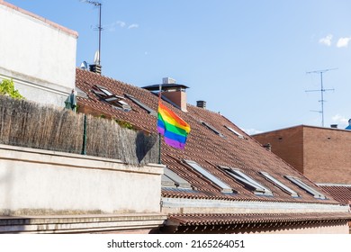 Madrid Spain. June 4, 2022. Pride Month. LGBT Flag Waving On The Tiled Roof Of A House. Celebrating Lgbtiq+ Rights On Pride Day.