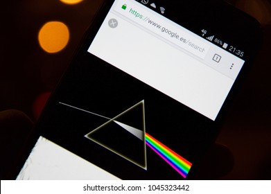 MADRID, SPAIN - MARCH 13: Pink Floyd's Dark Side of the Moon disc on a mobile phone with defocused Bokeh effect background on March 13, 2018 in Madrid, Spain.