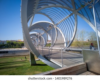 Madrid / Spain - March 17, 2019: The Arganzuela footbridge. It is a modern metal bridge outdoors located in the Madrid Rio green park near Madrid beach and across the Manzanares river