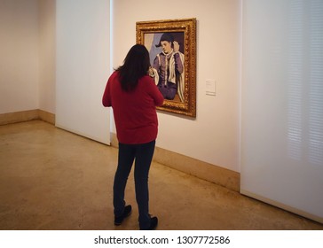 MADRID, SPAIN - MARCH 26, 2018: A Woman Looks At A Picture Of Pablo Picasso 