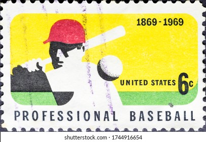 MADRID, SPAIN - MARCH 6, 2020. Vintage stamp printed in USA shows professional baseball, the first professional baseball team, the Cincinnati Red Stockings, baseball player while hitting the ball