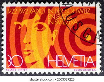 MADRID, SPAIN - MARCH 7, 2021. Vintage Stamp Printed In Switzerland Shows Radio 50th Anniversary (1922 - 1972), Woman Face And Radio Waves